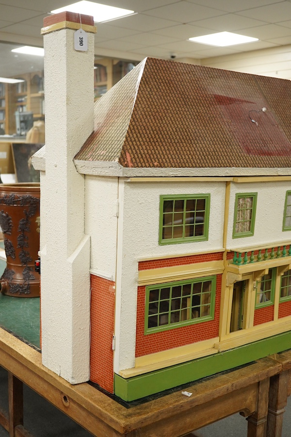 A modern ‘Vine House’ dolls house with furniture and accessories; a large six room house with hall and stairwell, the front wall opening in two sections on hinges each side, with internal decoration and lighting, width 1